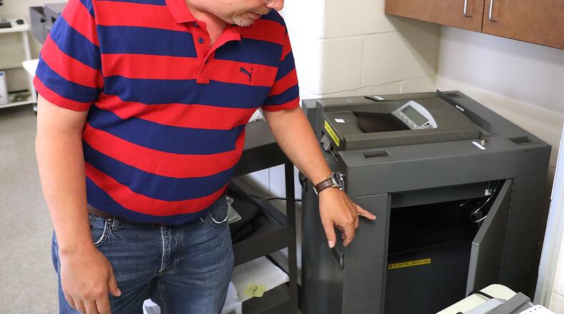 Clark County Board of Elections Director Jason Baker talks about some the repairs that have had to be made on some of the County’s aging voting machines. Bill Lackey/Staff