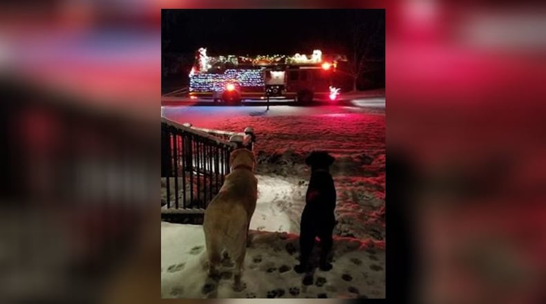9-year-old dog Abbey shows 7-month-old Sophie the Enon Christmas Parade and Santa Claus. Contributed photo by Rosalie Grasaglio Gibler