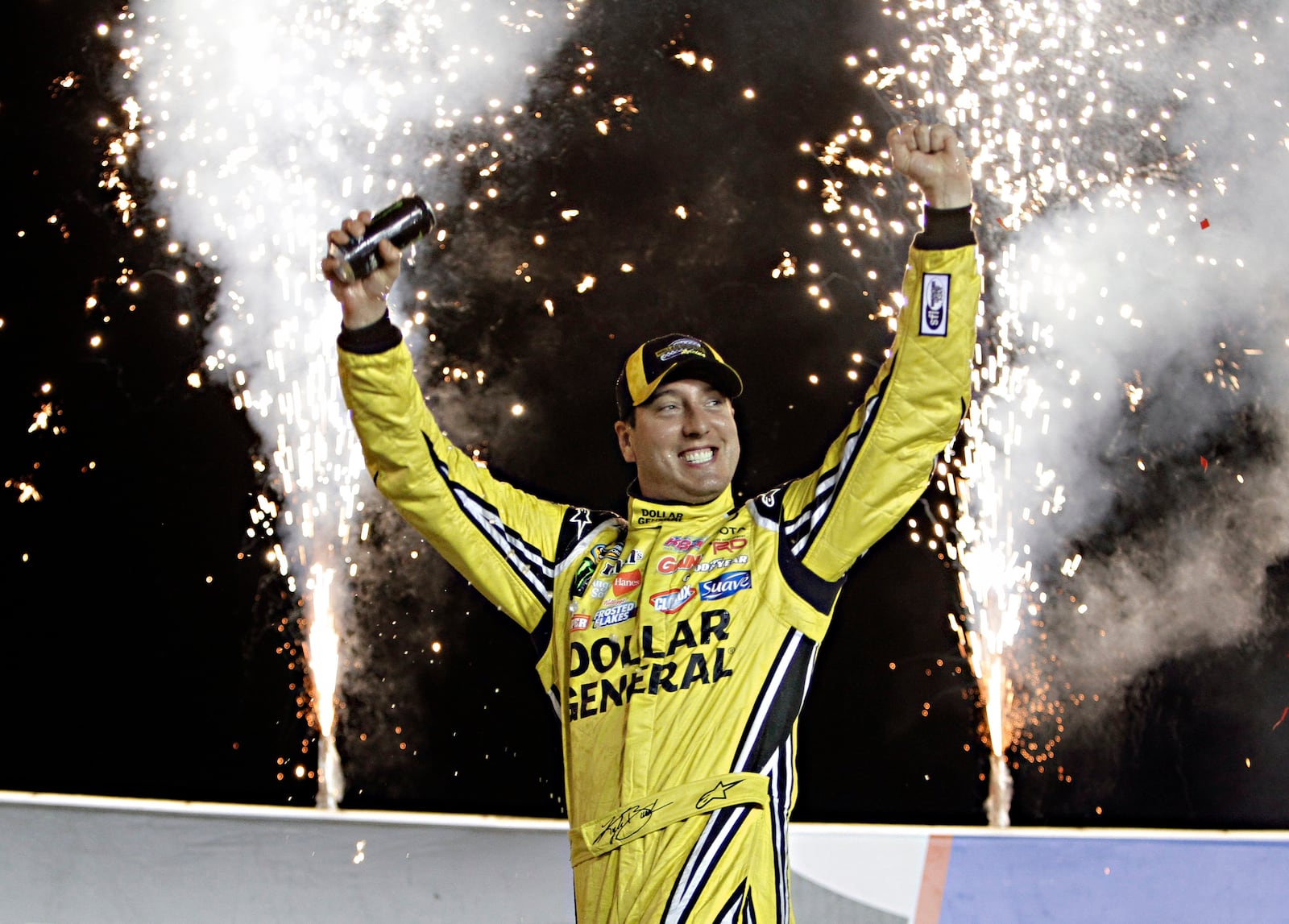 FILE - Kyle Busch celebrates in Victory Circle after winning the NASCAR Trucks auto race at Kentucky Speedway in Sparta, Ky., June 26, 2014. (AP Photo/Garry Jones, file)