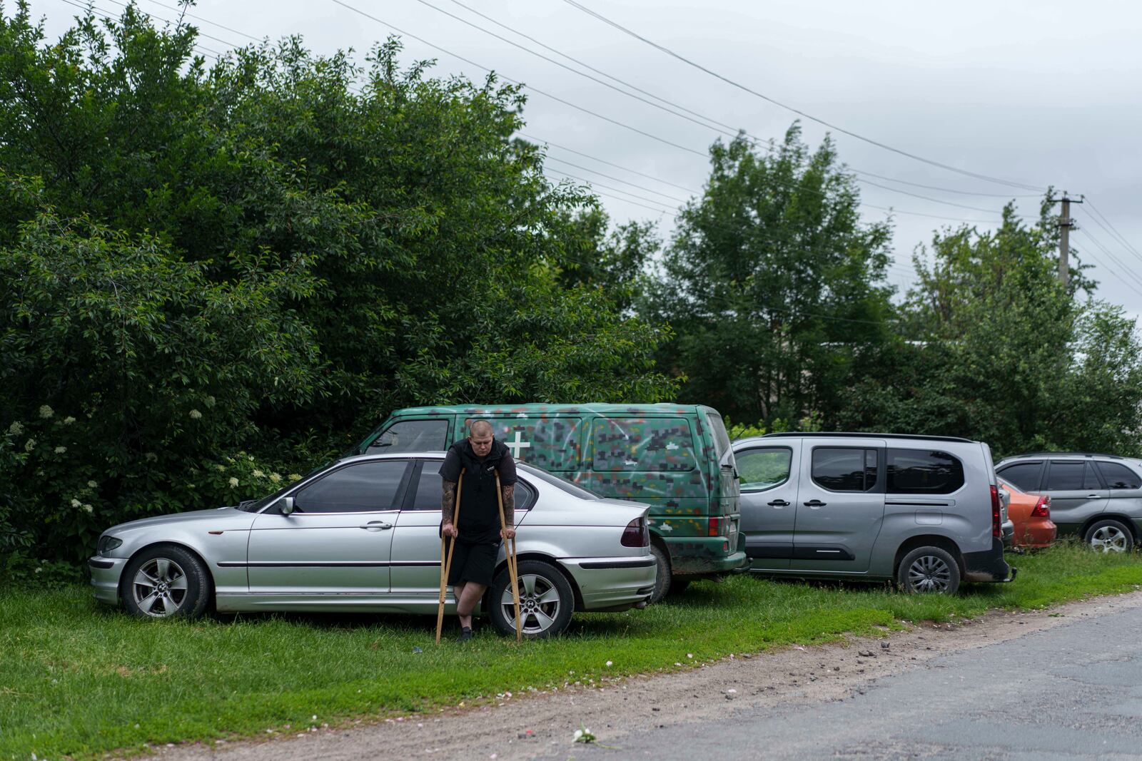 A former Ukrainian soldier with an amputated limb participates the funeral ceremony for his comrade Dmytro Shapovalov in Yosypivka village, Vinnytsia region, Ukraine, on Friday, June 13, 2025. (AP Photo/Evgeniy Maloletka)