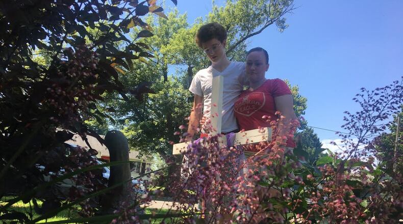 Teddi Litteral, the mother of 19-year-old homicide victim Cobey Etherington, and Kellen Etherington, his brother, stand in front of a memorial created for Cobey Etherington. STAFF PHOTO PARKER PERRY
