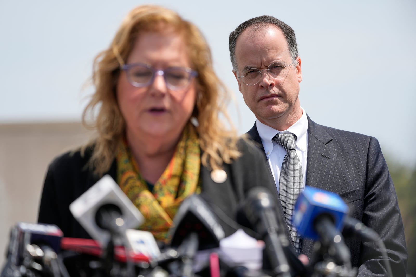 Acting U.S. Attorney John J. Durham, right, listens as Nassau County District Attorney Anne Donnelly speaks during a news conference after former U.S. Rep. George Santos was sentenced to more than seven years in prison for fraud and identity theft, Friday, April 25, 2025, in Central Islip, N.Y. (AP Photo/Julia Demaree Nikhinson)