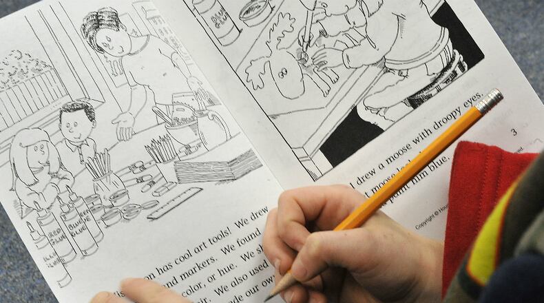 Third grade students at Lincoln Elementary practice their reading in class Thursday. Some local school districts plan to retain third grade students who don't pass the reading portion of the Ohio Achievement Assessment this year while others plan to promote the kids with interventions. Bill Lackey/Staff