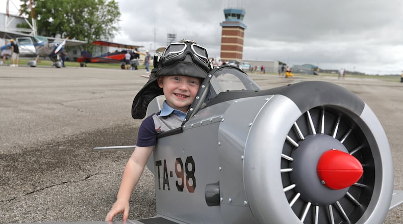 Winfield Dixon, 3, was pretending to be a flying ace in a pedal plane Saturday at the 2021 Barnstorming Carnival at the Springfield Beckley Airport. BILL LACKEY/STAFF