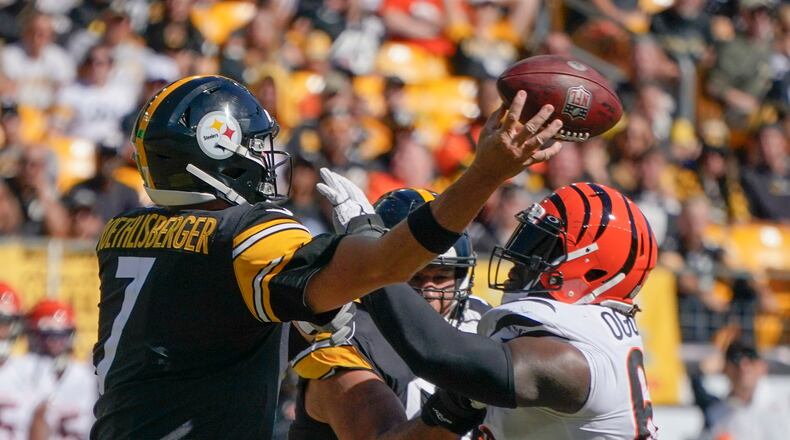 Cincinnati Bengals defensive tackle Larry Ogunjobi (65) hits Pittsburgh Steelers quarterback Ben Roethlisberger (7) as Roethlisberger passes during the second half an NFL football game, Sunday, Sept. 26, 2021, in Pittsburgh. (AP Photo/Gene J. Puskar)