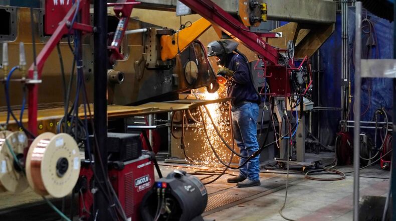 A worker grinds a weld on the latest version of the M1A2 Abrams main battle tank being built at the Joint Systems Manufacturing Center, Thursday, Feb. 16, 2023, in Lima, Ohio. (AP Photo/Carlos Osorio)