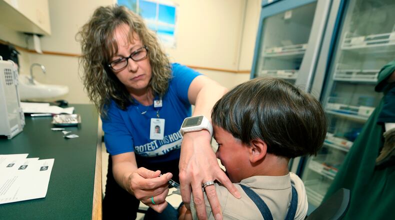 A registered nurse and immunization outreach coordinator with the Knox County Health Department, administers a vaccination to a kid at the facility in Mount Vernon, Ohio, Friday, May 17, 2019. In a report issued Wednesday, Nov. 23, 2022, the World Health Organization and the U.S. Centers for Disease Control and Prevention say measles immunization has dropped significantly since the coronavirus pandemic began, resulting in a record high of nearly 40 million children missing a vaccine dose last year. (AP Photo/Paul Vernon, File)