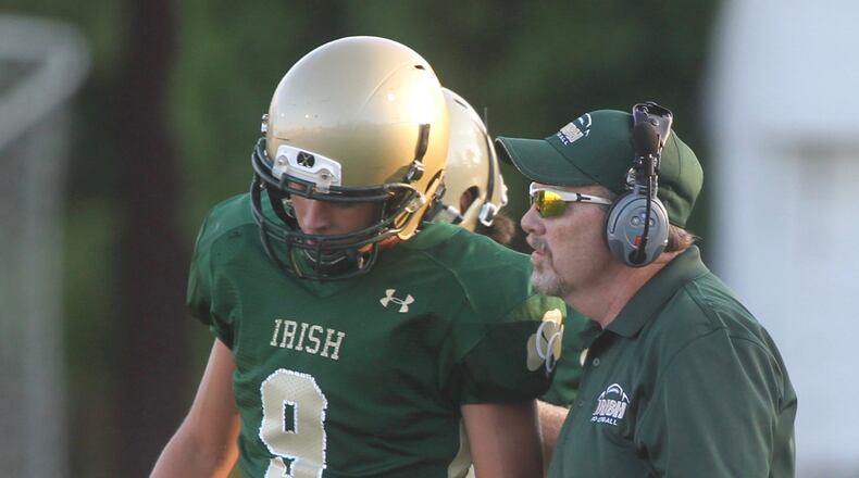 Catholic Central coach Mike McKenna, right, talks to Dominic DeWitt during a game against Graham on Friday, Sept. 2, 2016, at Hallinean Field in Springfield. David Jablonski/Staff