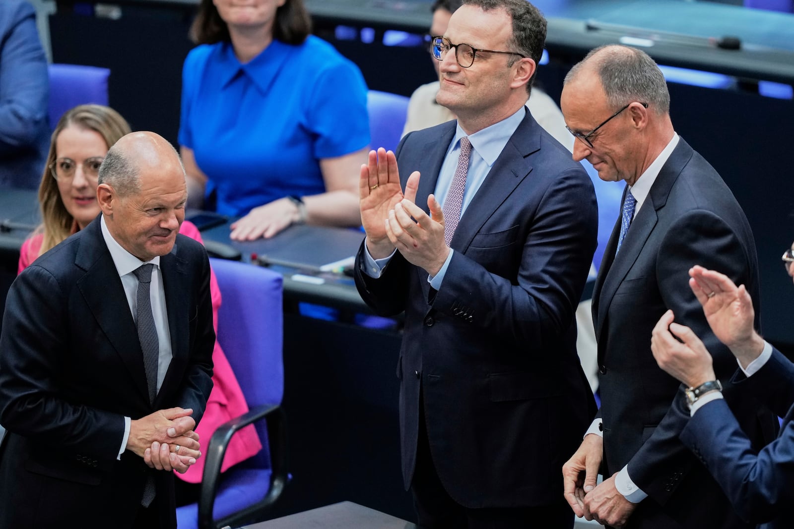 Leader of the Christian Democrats Friedrich Merz is congratulated by outgoing Chancellor Olaf Scholz after being elected new chancellor at the German federal parliament, Bundestag, at the Reichstag building in Berlin, Germany, Tuesday, May 6, 2025. (AP Photo/Ebrahim Noroozi)