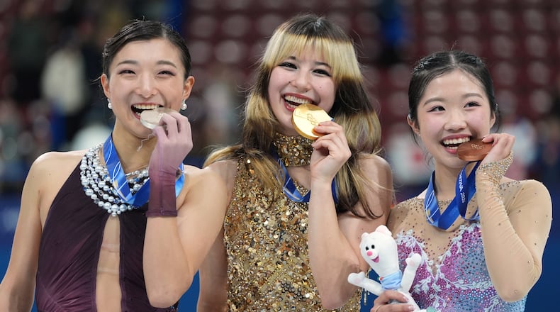 From left to right, silver medalist Kaori Sakamoto of Japan, gold medalist Alysa Liu of the United States, and bronze medalist Ami Nakai of Japan, pose with their their medals after competing in the women's free skate program in figure skating at the 2026 Winter Olympics, in Milan, Italy, Thursday, Feb. 19, 2026. (AP Photo/Stephanie Scarbrough)