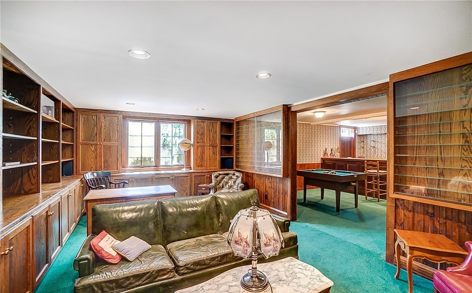 The finished basement includes a recreation room with bar and a home office with extensive built in bookcases and display cases.
