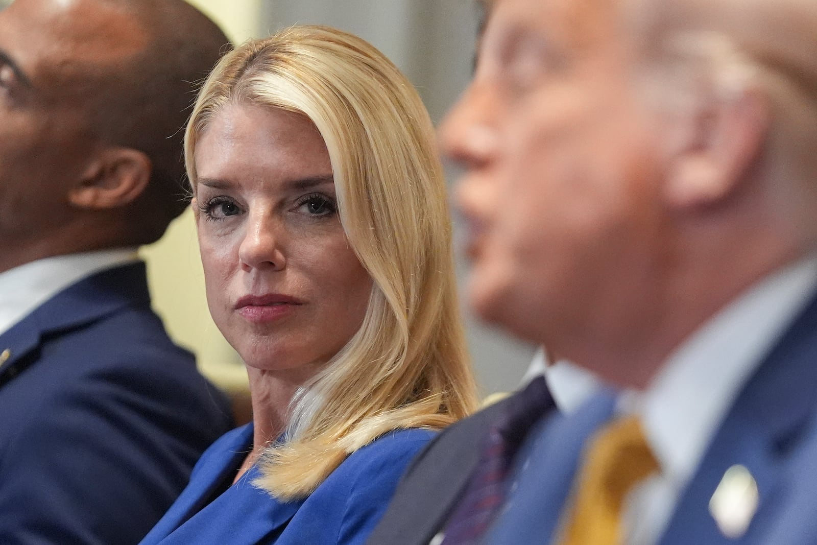 Attorney General Pam Bondi, left, listens as President Donald Trump, right, speaks during a cabinet meeting at the White House, Tuesday, July 8, 2025, in Washington. (AP Photo/Evan Vucci)