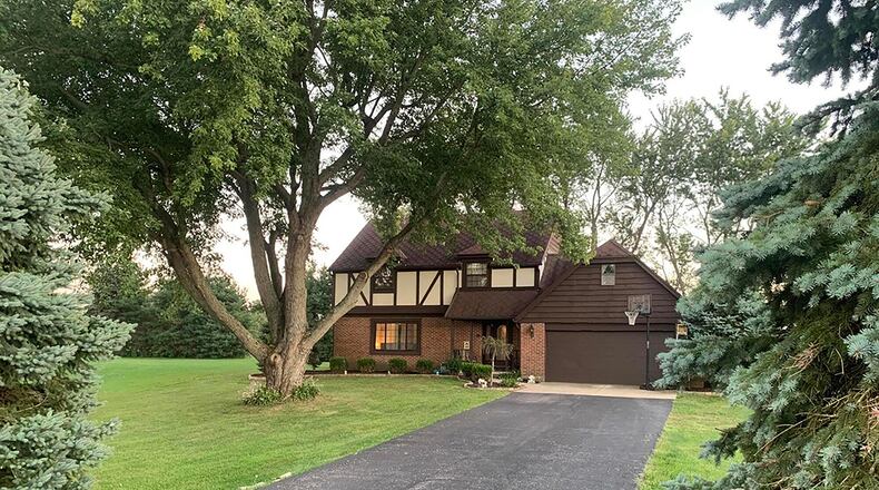 The Colonial-style home, which offers about 2,140 sq. ft. of living space with 4 bedrooms and 3 baths, features an attached, 2-car garage and covered front porch as well as landscaping and mature trees. CONTRIBUTED PHOTO