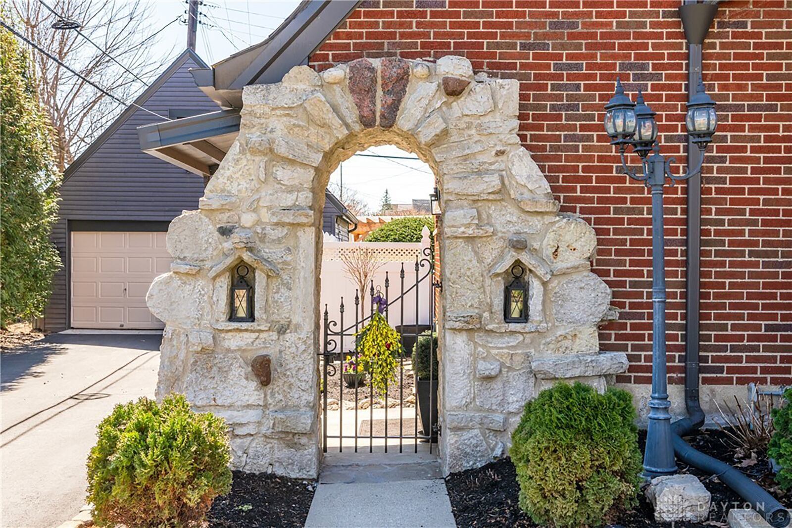 The home maintains its historical character with touches like this stone arch built into the main house and leading to the side patio.