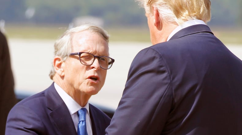 Ohio Governor Mike Dewine is greeted by President Trump at Wright-Patterson Air Force Base, Wednesday, Aug. 7, 2019, in Dayton, Ohio. Trump is in Dayton to visit with families of victims of the mass shooting that took place here on Sunday.(Ty Greenlees/Dayton Daily News/pool)
