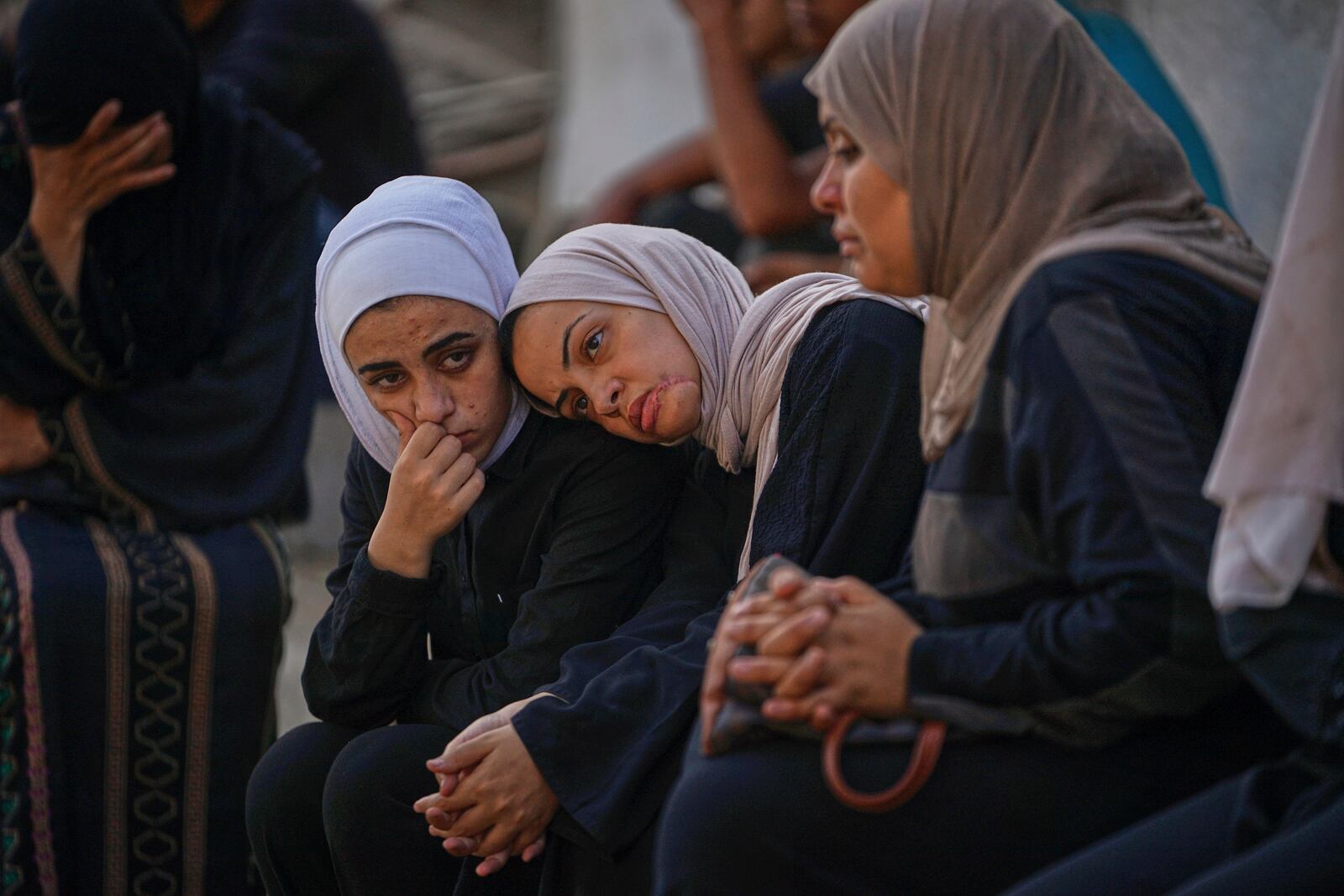 Relatives of Palestinians killed in Israeli army strikes wait for their burial at Shifa hospital in Gaza City, Thursday, June 26, 2025. (AP Photo/Jehad Alshrafi)
