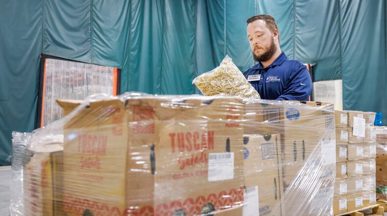 Executive director Alex Jackson determines what food is in certain boxes at Second Harvest Food Bank on Thursday, Nov. 13, 2025, in Springfield. JOSEPH COOKE/STAFF