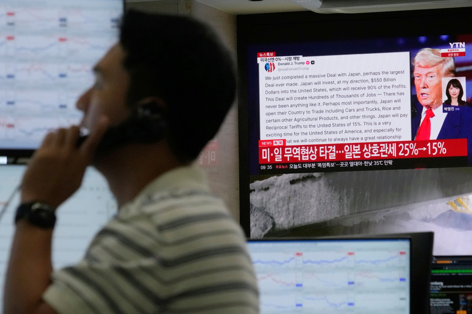 A currency trader works near the screen showing news reporting with a picture of President Donald Trump at the foreign exchange dealing room of the Hana Bank headquarters in Seoul, South Korea, Wednesday, July 23, 2025. (AP Photo/Ahn Young-joon)