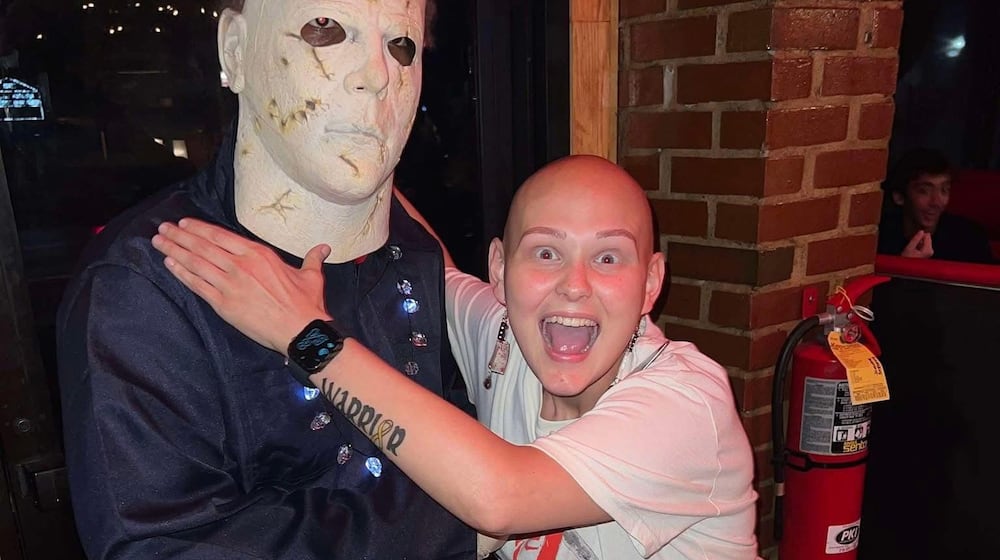 The Cromlish family on South Sweetbriar Lane in Springfield hosts a haunted house in their front yard for for trick-or-treaters. In this photo is Rikki-Lynn with Michael Myers. CONTRIBUTED