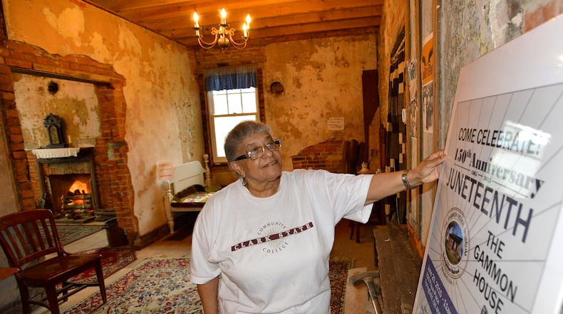 Betty Grimes looks over the sign on display in the Gammon House for the 2015 Juneteenth Celebration. Bill Lackey/Staff