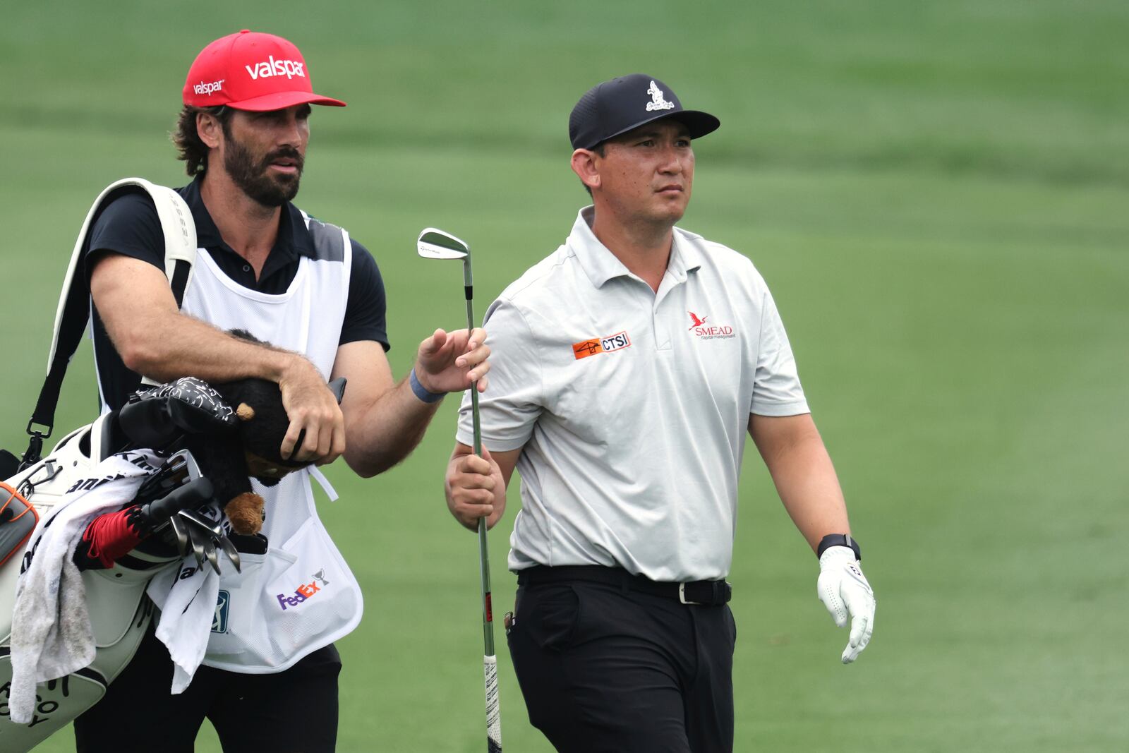 Rico Hoey, right, and his caddie approach the 8th green during the first round of the CJ Cup Byron Nelson golf tournament in McKinney, Texas, Thursday, May 1, 2025. (AP Photo/Gareth Patterson)
