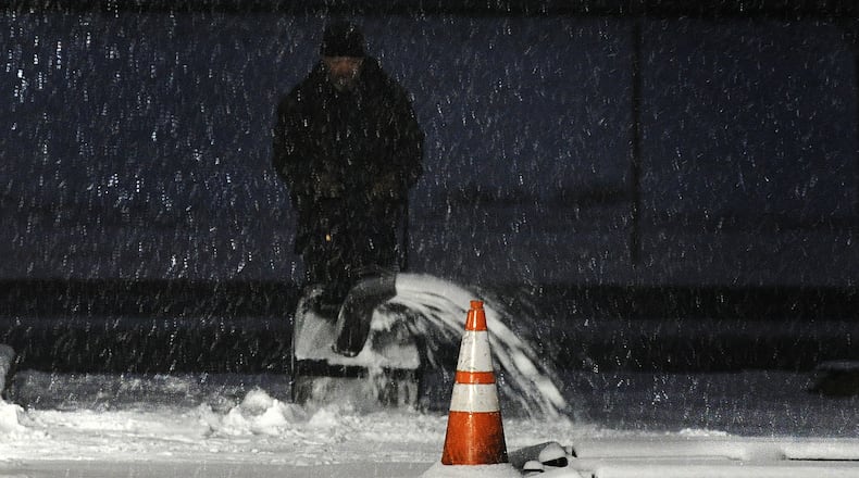 Snowy weather Friday morning, Jan. 19, 2024 had people starting their snowblowers to clear driveways and sidewalks in Fairborn. MARSHALL GORBY\STAFF