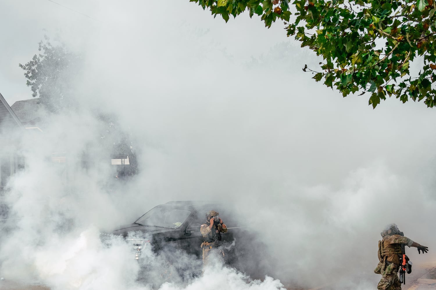 A federal agent tosses a tear gas canister toward a crowd of people during a clash with community members on the southeast side of Chicago on Tuesday, Oct. 14, 2025. The agents were in the neighborhood as part of the Trump administrationÕs immigration initiative known as Operation Midway Blitz. (Jamie Kelter Davis/The New York Times)