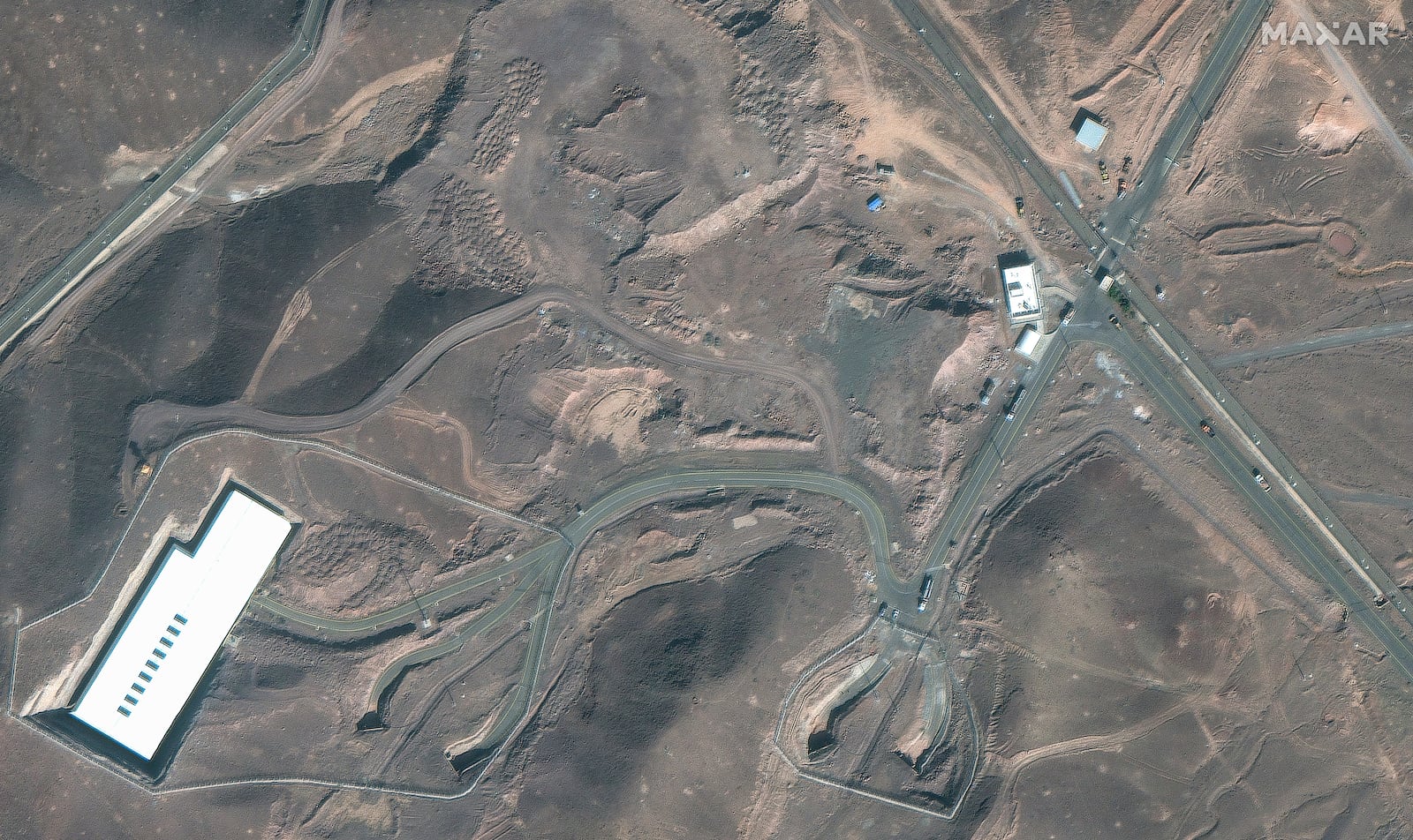 This satellite image provided by Maxar Technologies shows vehicles at the Fordo enrichment facility in Iran on Friday, June 20, 2025. (Maxar Technologies via AP)