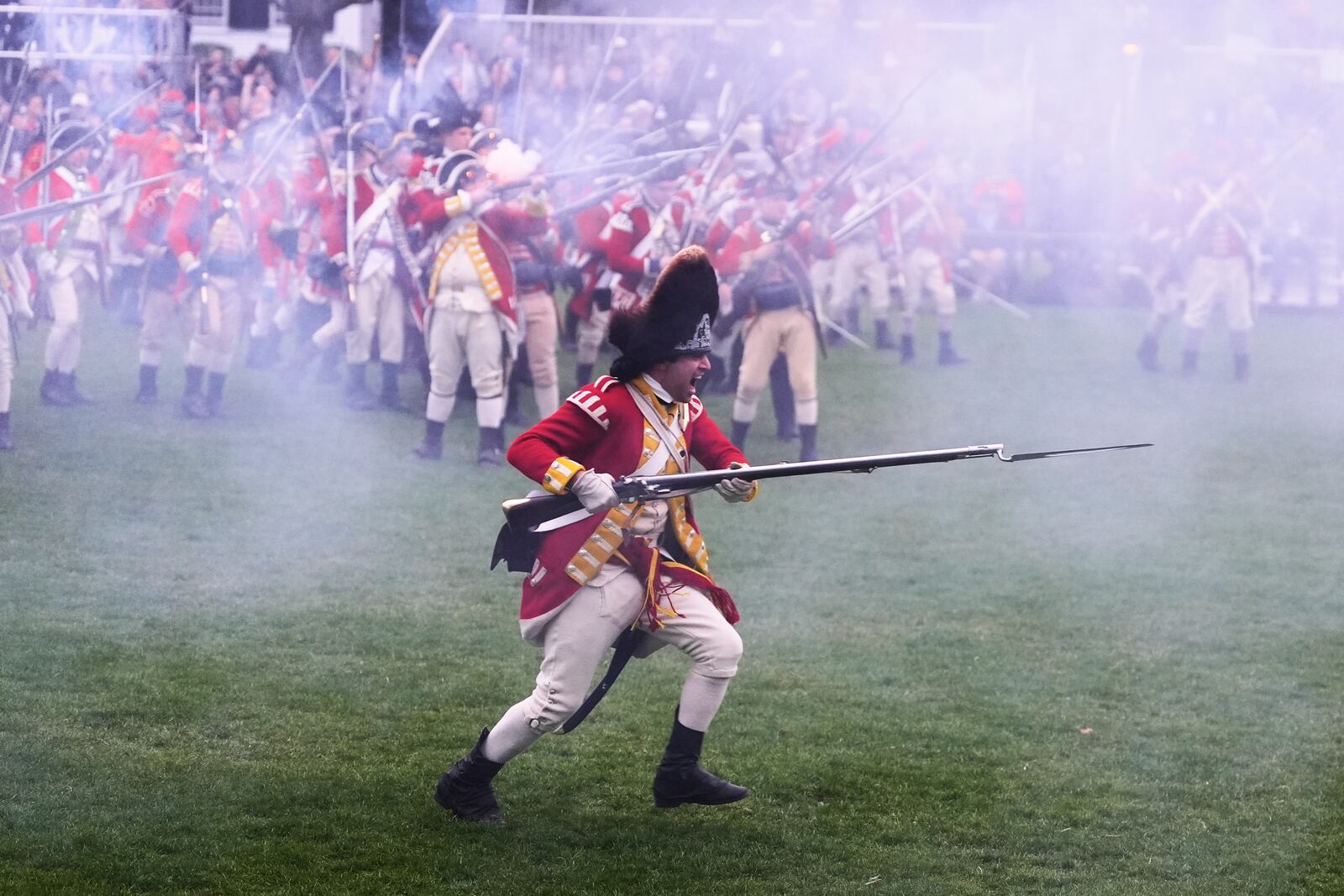 British Regulars advance on New England colonial militia, also known as a Minutemen, during a reenactment celebration of the 250th anniversary of the Battle of Lexington and start of the American Revolution, Saturday, April 19, 2025, in Lexington, Mass. (AP Photo/Charles Krupa)