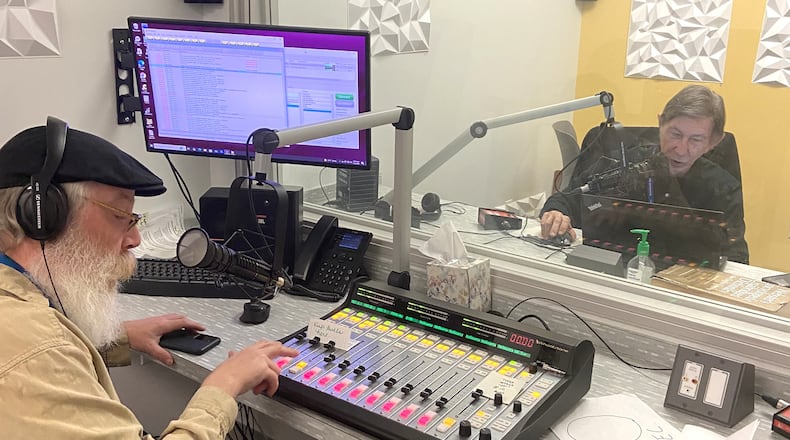 Volunteer Steve Popp (right) reads the Dayton Daily News while Eric Henry mans the control board at the Radio Reading Service studio in the Goodwill Easterseals Miami Valley building. CONTRIBUTED