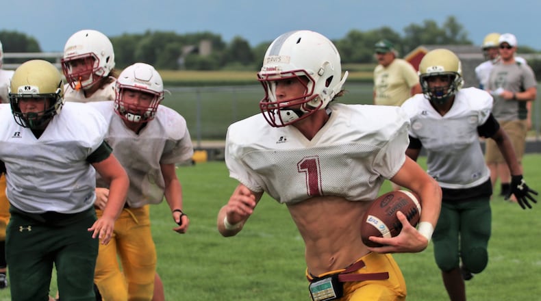 Northeastern senior quarterback Mac Davis makes a gain during a scrimmage against Catholic Central on Tuesday, Aug. 8, 2018. MICHAEL COOPER / CONTRIBUTOR