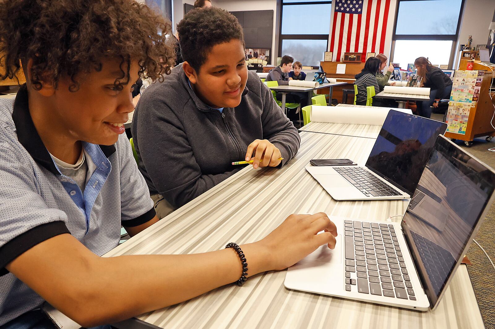 Caleb Bryant, left, and Donovan Stewart, both students at the Global Imapact STEM Academy work on a history project in class Tuesday, March 28, 2023. BILL LACKEY/STAFF