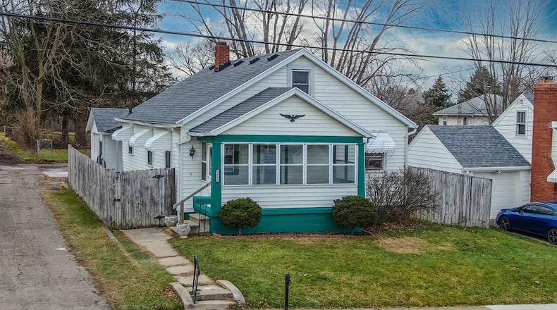The 3-bedroom home offers about 1,200 sq. ft. of living space. The front features a fully enclosed porch with ceiling fan and carpeted floor. CONTRIBUTED PHOTO