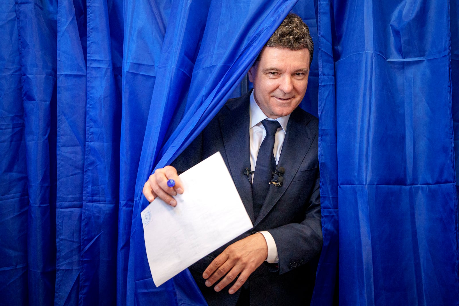 Presidential candidate Nicusor Dan exits a voting booth before casting his vote in the first round of the presidential election redo in Bucharest, Romania, Sunday, May 4, 2025. (AP Photo/Andreea Alexandru)