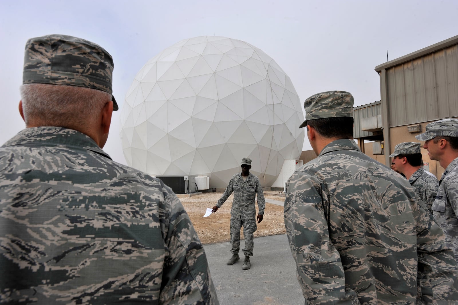 This handout photo from the U.S. Air Force shows Lt. Col. Carlos Alford, 379th Expeditionary Communications Squadron commander, in front of the Modernized Enterprise Terminal at Al Udeid Air Base, Qatar, Jan. 21, 2016. (Master Sgt. Joshua Strang/U.S. Air Force via AP)