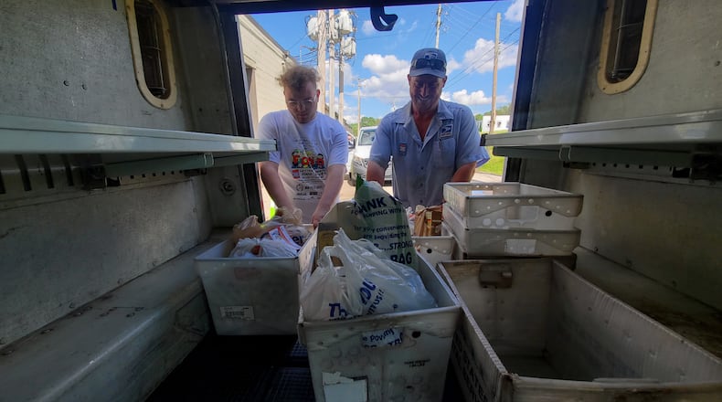 A Letter Carrier and volunteer unload donations during the 2024 Stamp Out Hunger Food Drive. Contributed/Photo by Allie Godfrey.