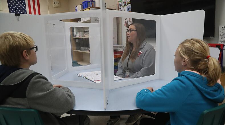 Schools in Clark and Champaign counties have reported 56 COVID-19 cases for the week of Oct. 18-24, including three at Triad. Here, Katie Organ works students in the Flood Program at Triad Elementary. The Flood program allows extra teachers to work with students in smaller groups to offer assistance where it's needed. BILL LACKEY/STAFF