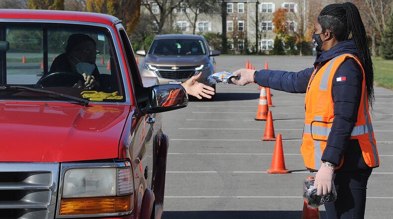 Michelle Buford, a facilities Specialist for the city of Dayton, helped to pass out masks near Kettering Fields. The mask are free of charge. MARSHALL GORBY\STAFF