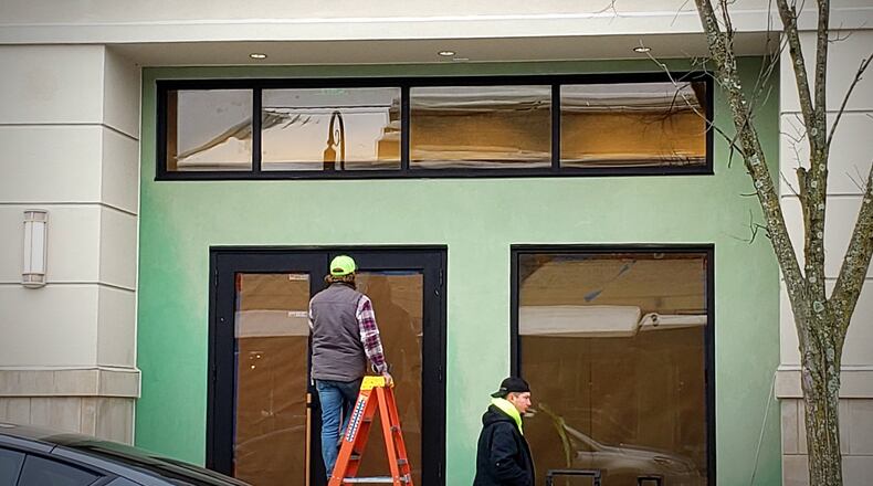 Workers prepare the Anthropologie storefront ahead of its Jan. 15 opening, January 10, 2025. LONDON BISHOP/STAFF