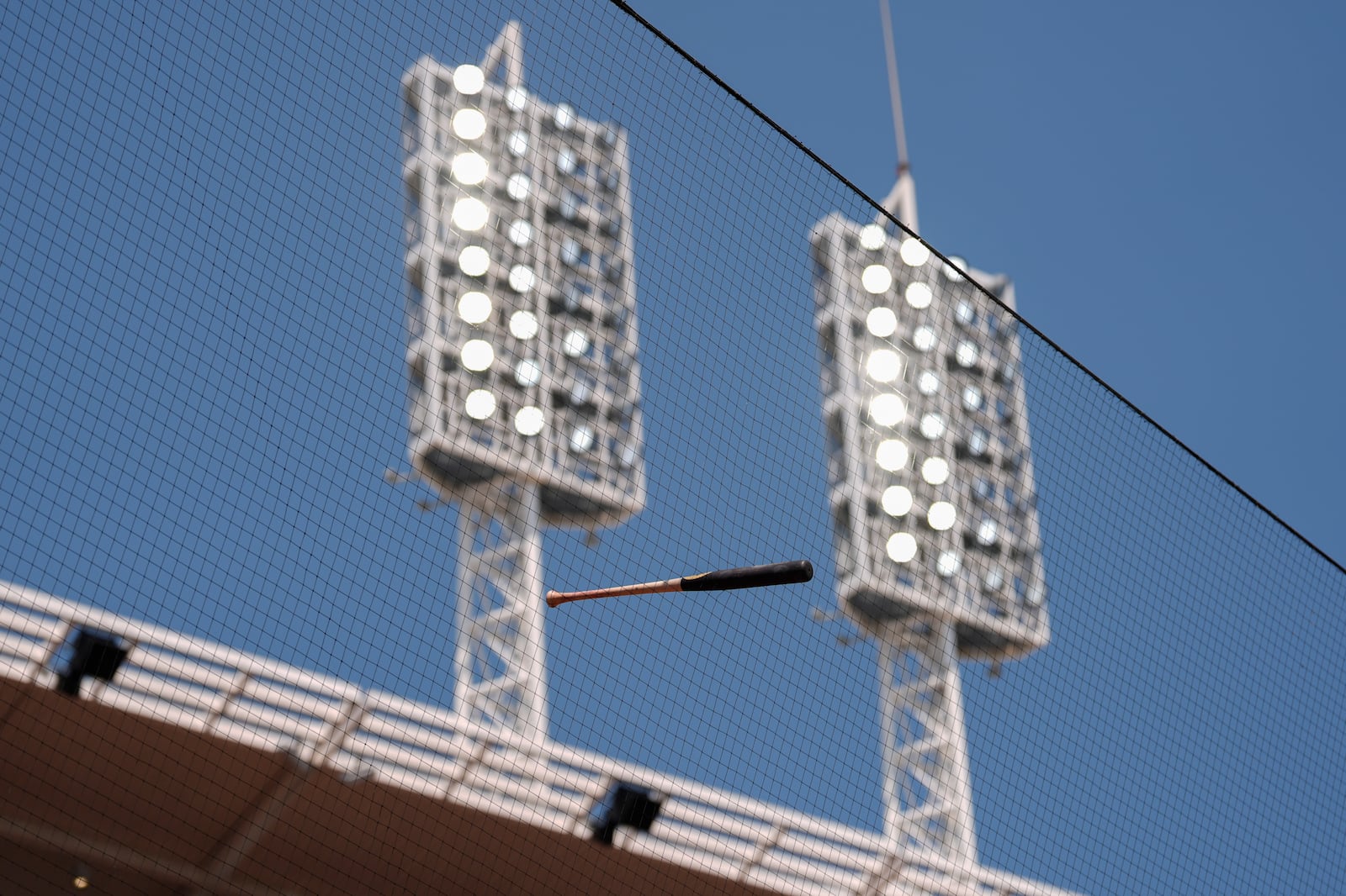 Cincinnati Reds' Elly De La Cruz's bat is seen hanging high in the safety netting after a baseball game between the Cincinnati Reds and the Atlanta Braves, Friday, Aug. 1, 2025, in Cincinnati. De La Cruz lost control of his bat during the eighth inning. (AP Photo/Carolyn Kaster)