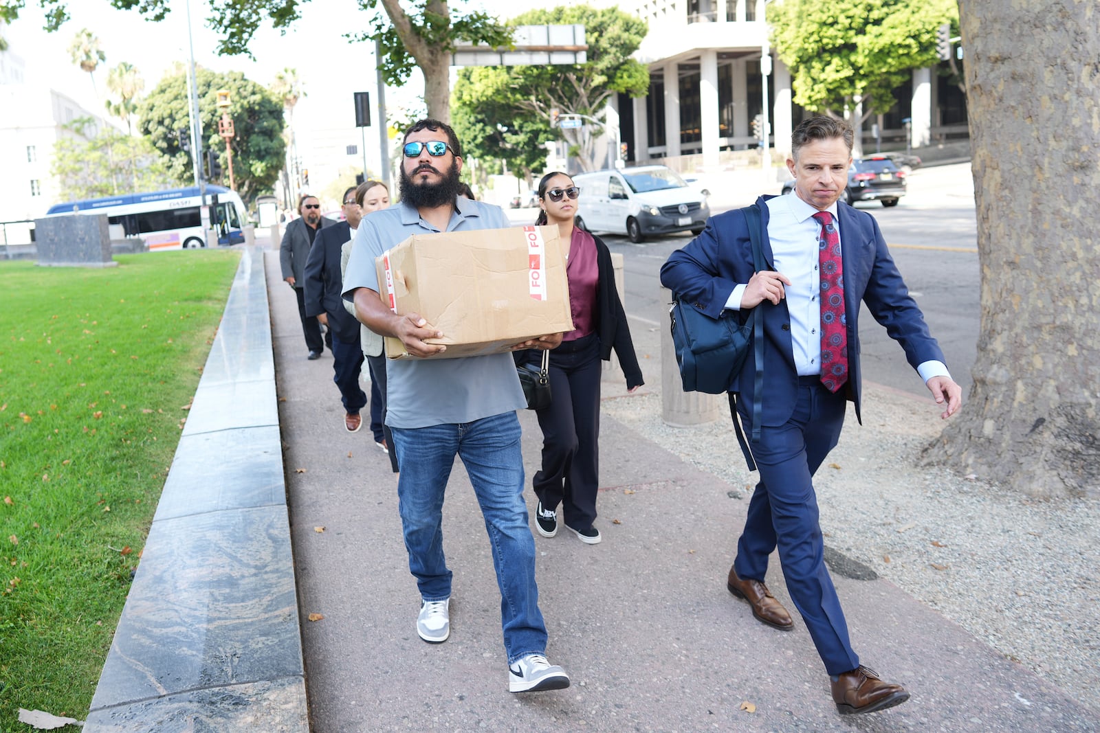 From left, Felix Rubio, Kim Rubio and attorney Josh Koskoff arrive for a court hearing in a lawsuit between victims' families in the 2022 Uvalde, Texas school shooting and Meta Platforms on Friday, July 18, 2025, in Los Angeles. (AP Photo/Eric Thayer)