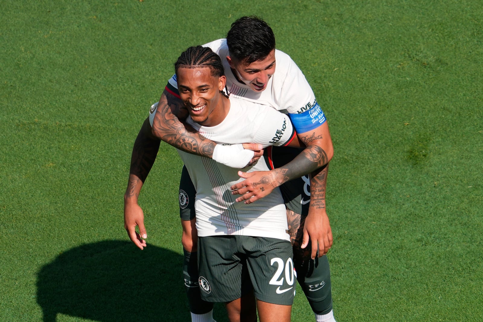 Chelsea's Joao Pedro (20) is congratulated by Enzo Fernandez after scoring his side's 2nd goal during the Club World Cup semifinal soccer match between Fluminense and Chelsea in East Rutherford, N.J., Tuesday, July 8, 2025. (AP Photo/Pamela Smith)