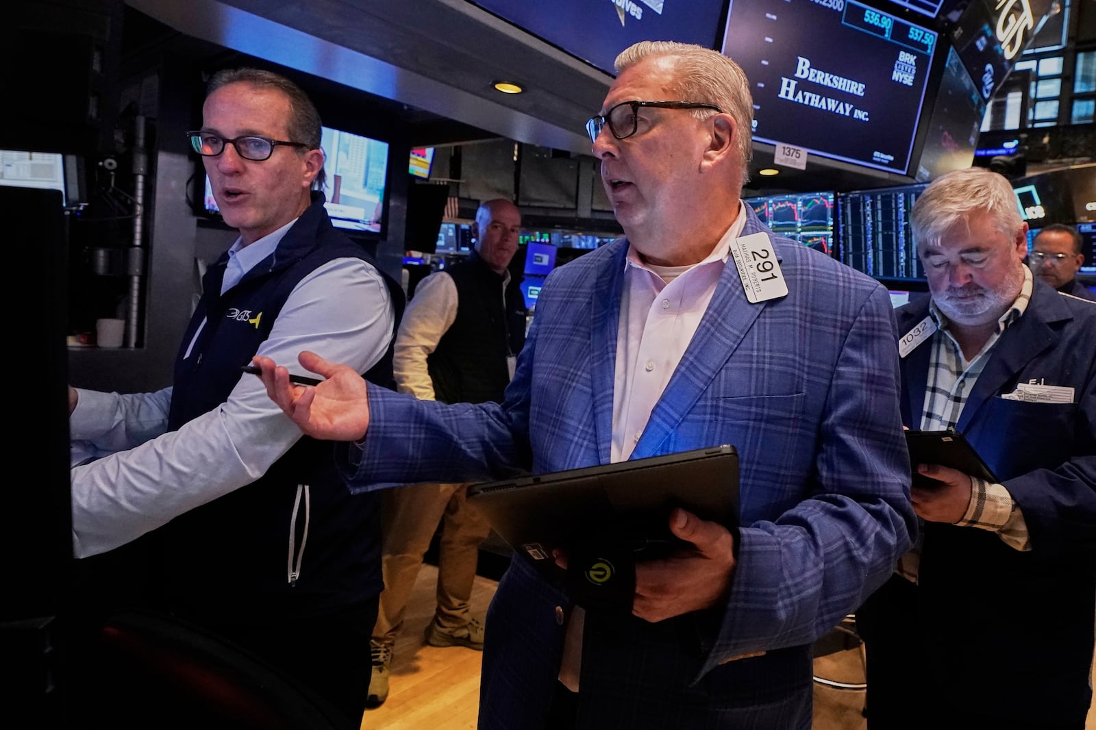 Specialist Glenn Carell, left, and trader Mathias Roberts, center, work on the floor of the New York Stock Exchange, Friday, May 2, 2025. (AP Photo/Richard Drew)