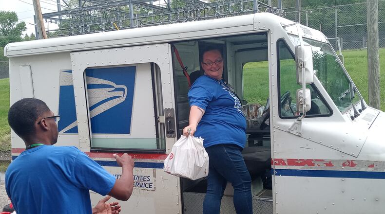Second Harvest Food Bank staff, volunteers, and Letter Carriers receive and sort donated food during the 2023 Stamp Out Hunger food drive. Contributed