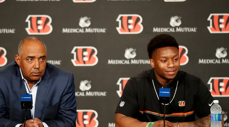 Cincinnati Bengals second-round draft pick Joe Mixon, right, is interviewed alongside head coach Marvin Lewis, left, during a news conference at Paul Brown Stadium, Saturday, April 29, 2017, in Cincinnati. The former Oklahoma running back was selected as the 48th overall pick. (AP Photo/John Minchillo)