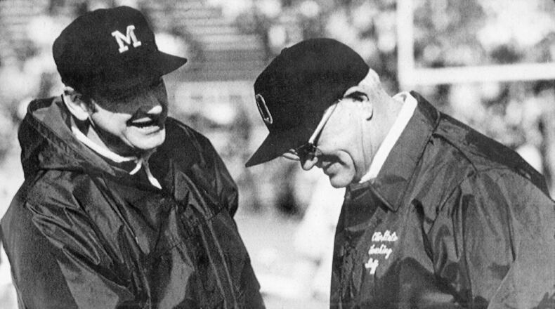 FILE - Michigan coach Bo Schembechler, left, meets with Ohio State coach Woody Hayes at an NCAA college football game. Ohio State and Michigan are making the Big Ten look like the Big Two and Little 12, rekindling memories of Woody Hayes and Bo Schembechler turning the chase for a conference championship into a two-team race. (AP Photo/File)