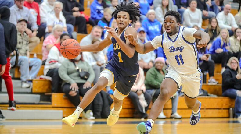 Springfield High School sophomore CJ Wallace drives past Miamisburg junior Chrys Nogh during their game on Friday night in Miamisburg. The Vikings won 54-44. CONTRIBUTED PHOTO BY MICHAEL COOPER