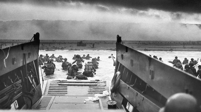 A photo provided by the National Archives shows U.S. Army soldiers of Company E, 16th Infantry, 1st Infantry Division landing on Omaha Beach in Normandy, northern France, as part of the initial invasion wave on D-Day, June 6, 1944.  Success of the D-Day invasion required a very specific set of weather conditions.  (Chief Photographer's Mate Robert M. Sargent/U.S. Coast Guard via The New York Times)