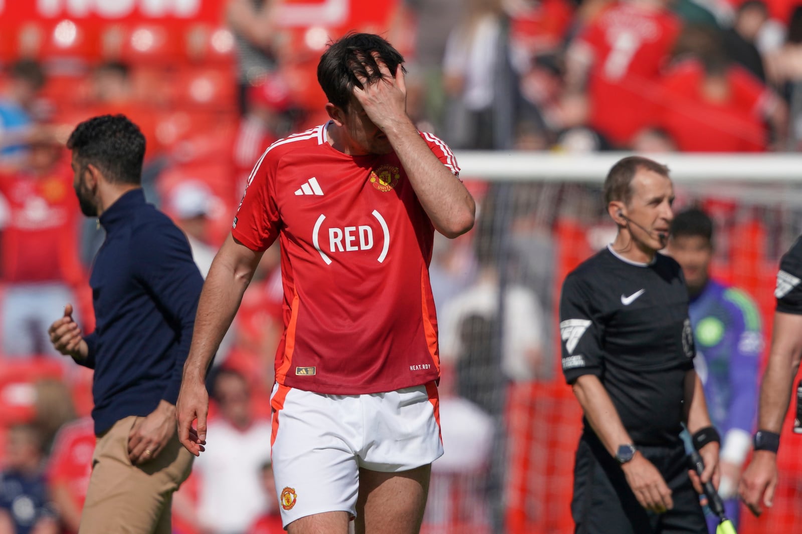 Manchester United's Harry Maguire walks on the pitch in dejection at the end of the English Premier League soccer match between Manchester United and West Ham at Old Trafford stadium in Manchester, England, Sunday, May 11, 2025. (AP Photo/Ian Hodgson)