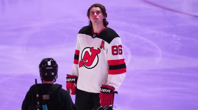 New Jersey Devils' Jack Hughes is honored along with other Olympic hockey players present before an NHL hockey game against the Pittsburgh Penguins in Pittsburgh, Thursday, Feb. 26, 2026. (AP Photo/Gene J. Puskar)
